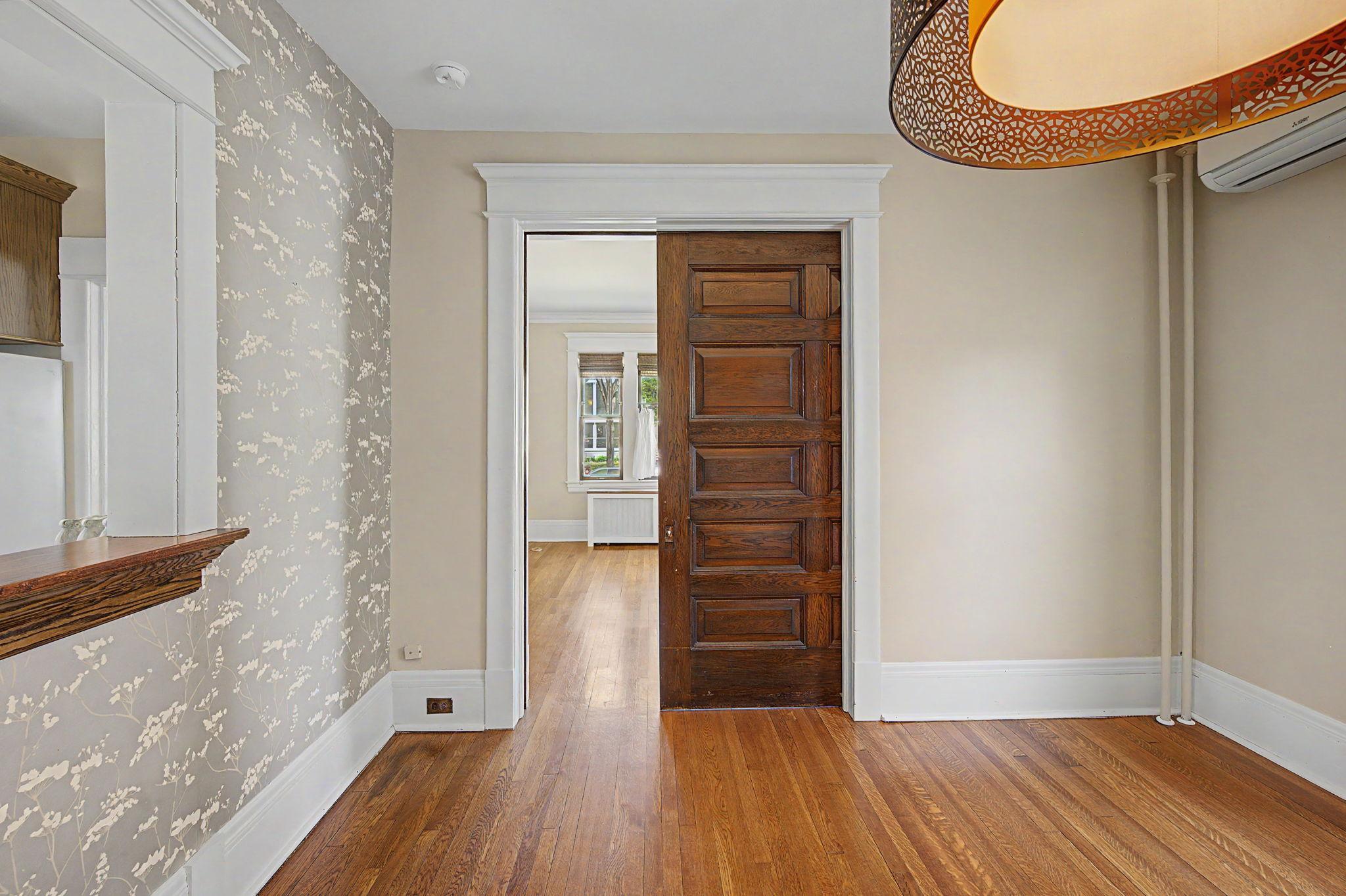 The sliding door between the living room and dining room can completely change the floor plan dividing the dining and living rooms or provide for more open space.
