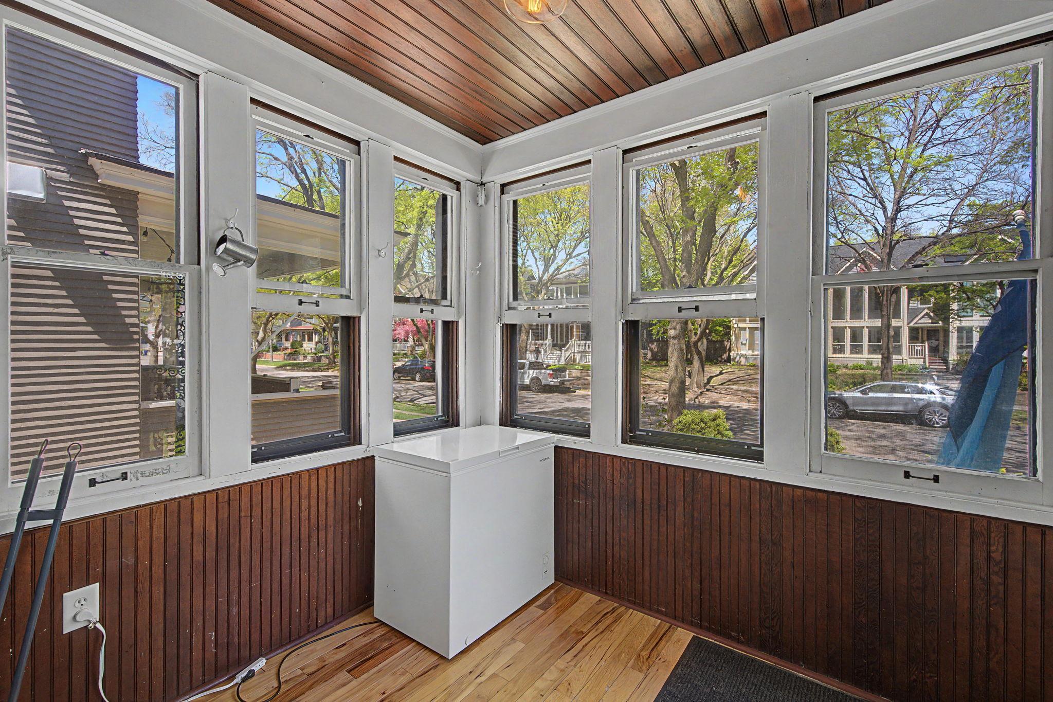 If it's raining, the front porch is an ideal place to hang out and relax safe from the outside elements. Currently a chest freezer is here.
