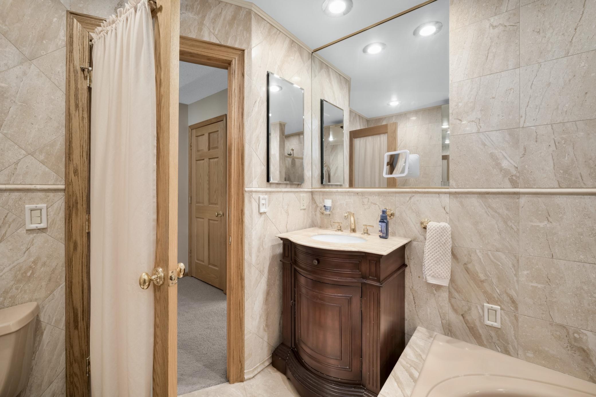 A stylish vanity and recessed lighting add the character