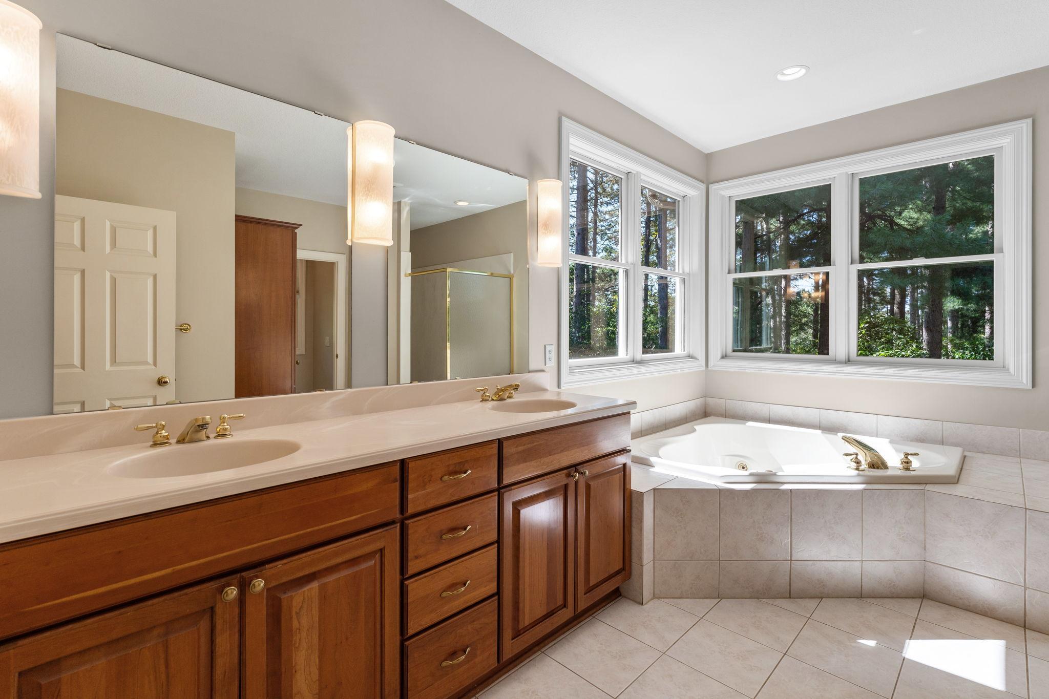 Main floor primary bath with separate tub & shower