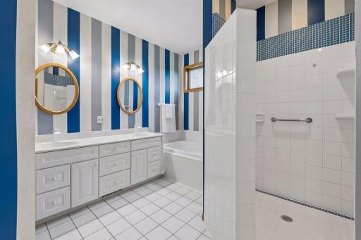 Primary bathroom with tile HEATED floors which is a bonus and luxury, dual vanity, separate jetted tub and tile surround walk in shower.