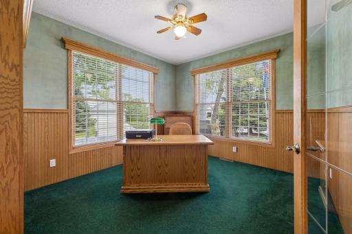Main level office with custom beadboard wanes coating and custom blinds throughout home.