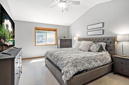 Private primary suite features vaulted ceilings, private 3/4 bath and walk in closet