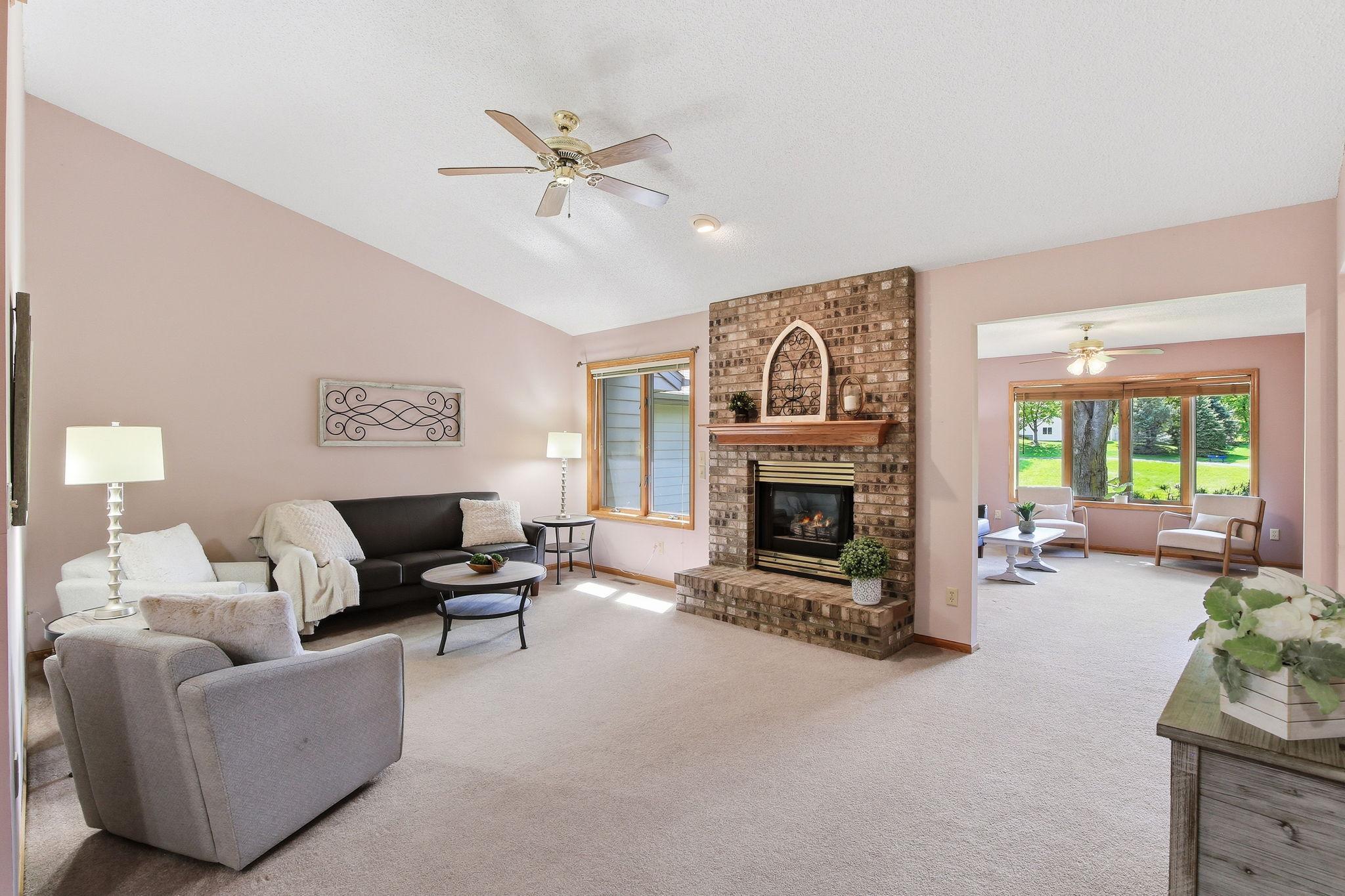 Vaulted Living Room with Gas Fireplace Open to the Sunroom.