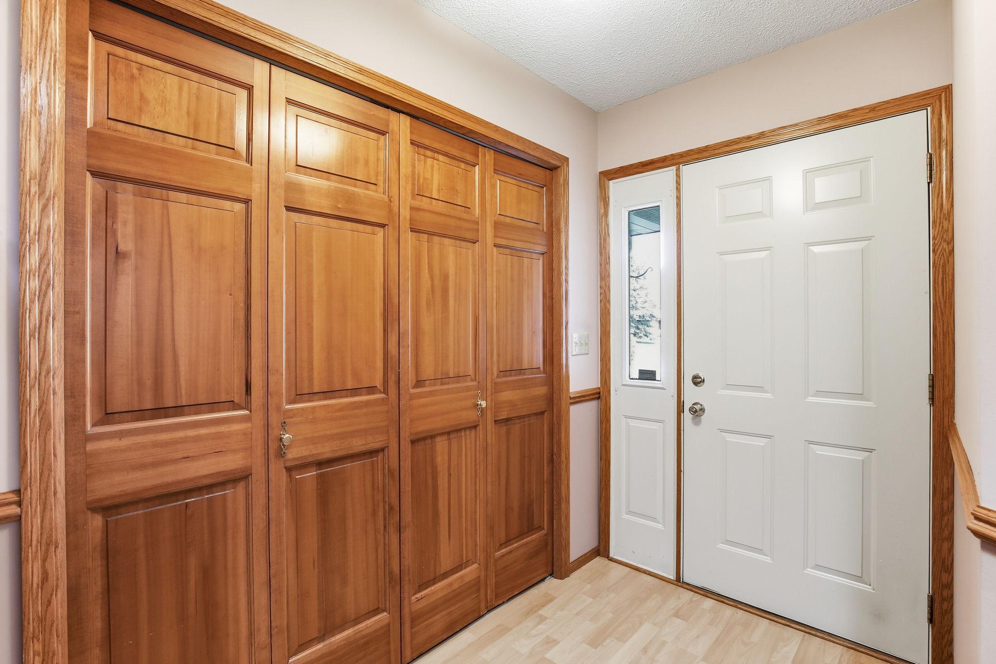 Front entry shows the large closet and 6-panel doors.