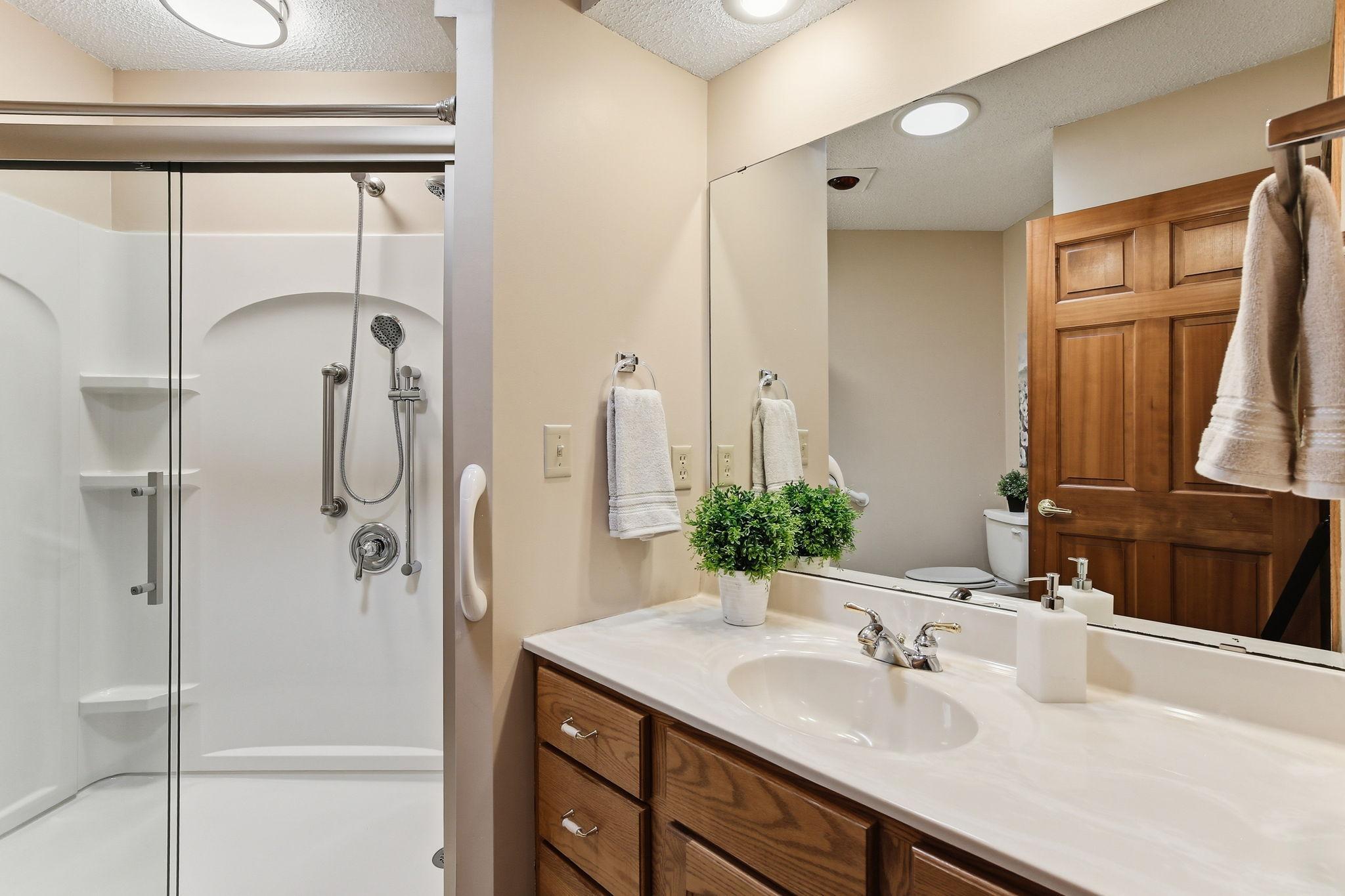 Updated Main/Guest Bath has a newer walk-in shower.