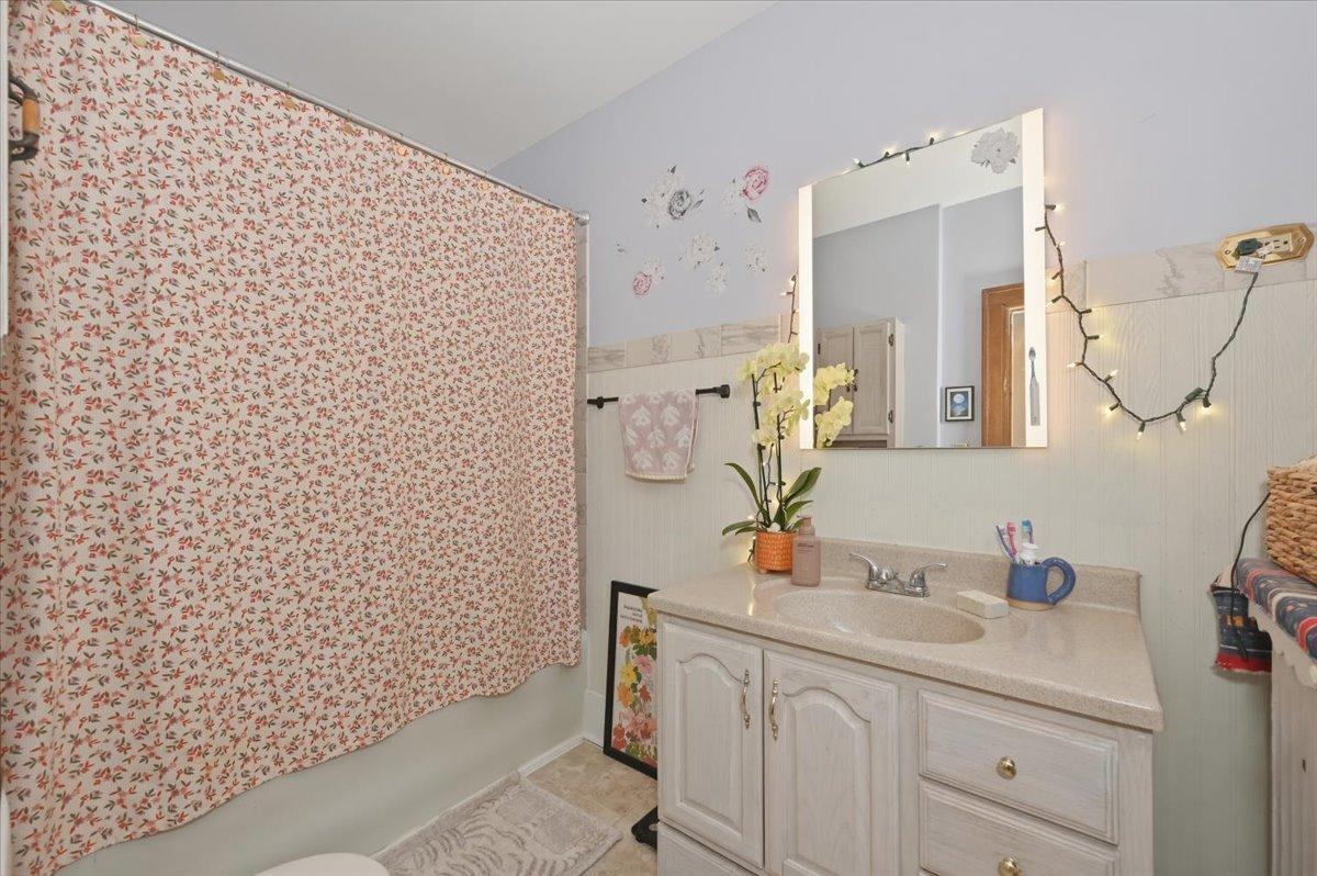Full bath on second story, tiled tub surround.