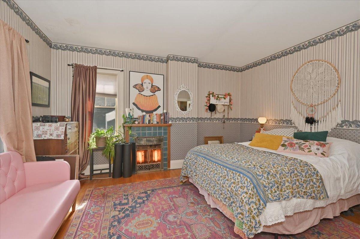 Primary bedroom with electric fireplace.