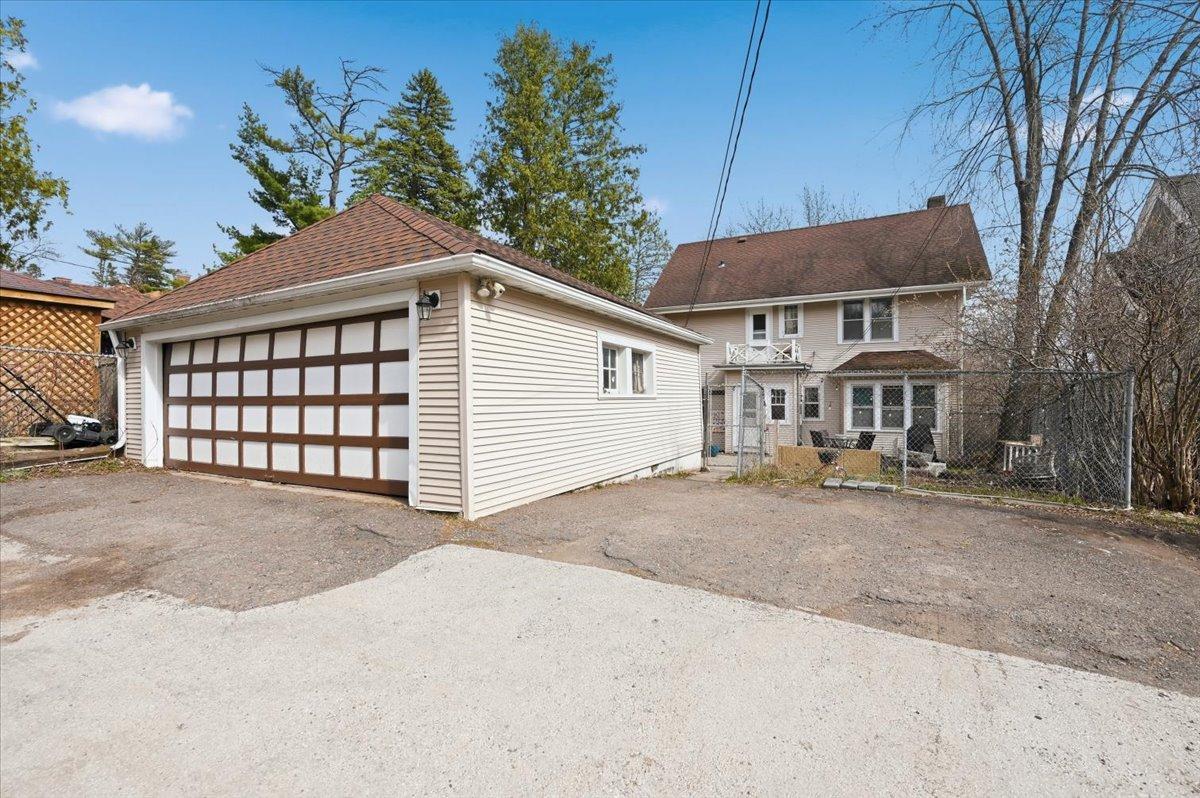2-car garage with additional 2 parking spaces to the right of the garage. (There is room to park a 5th car in front of the garage door.)
