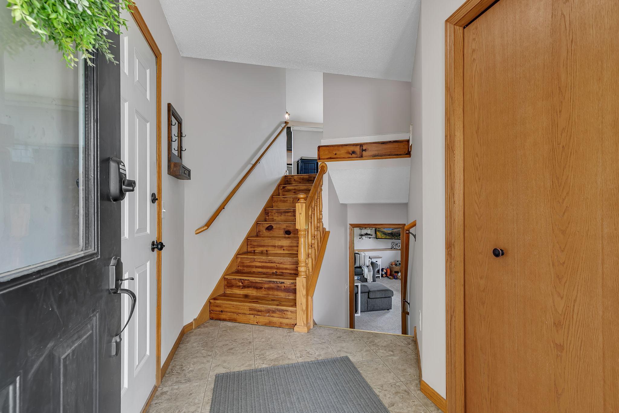 Large foyer with attached garage access and storage closet