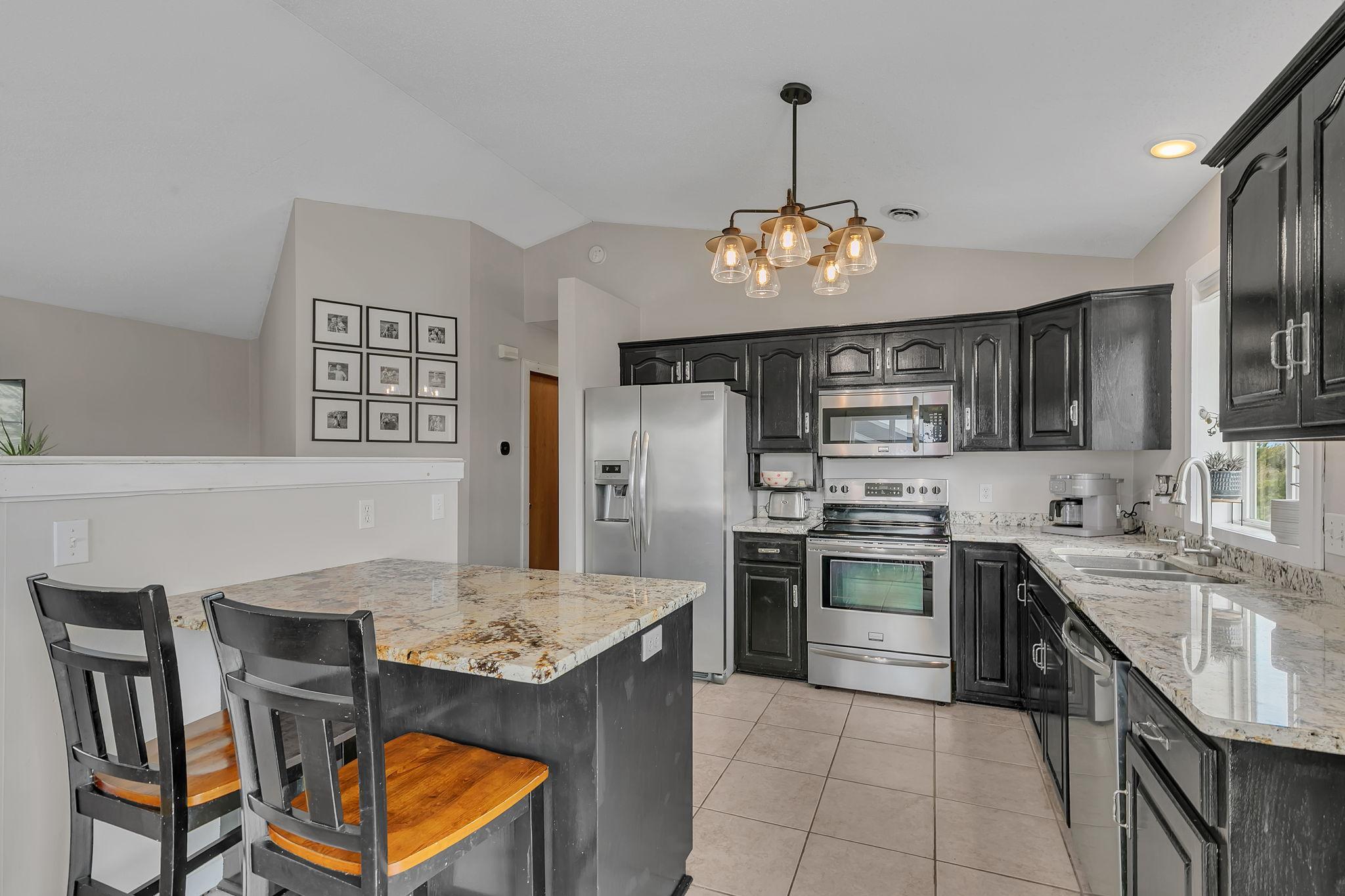 Granite countertops, stainless steel appliances and plenty of counter space with the center island