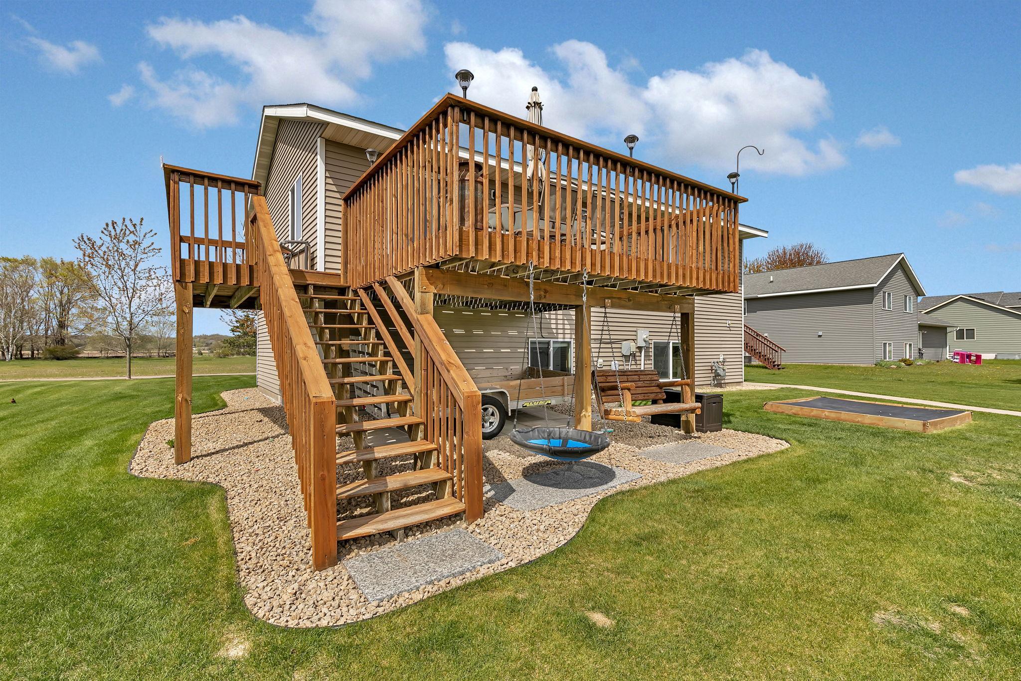 Granite pavers in the landscaping provide an elevated touch. Only wooden swing stays