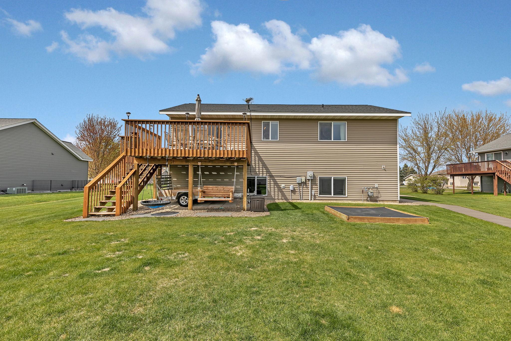 Spacious backyard, large deck off of the dining room stone firepit and covered sandbox