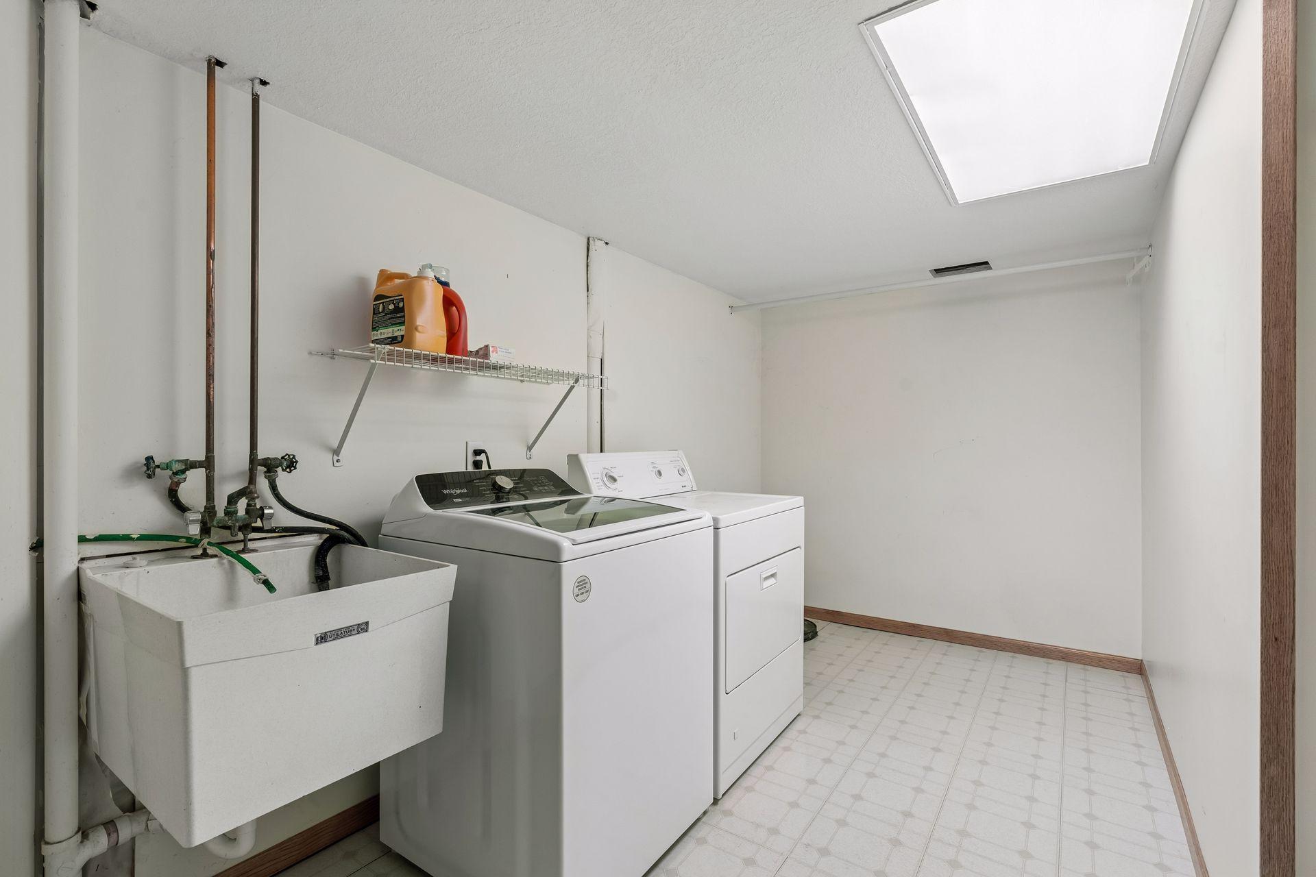 Large laundry room offers excellent storage space and functionality.