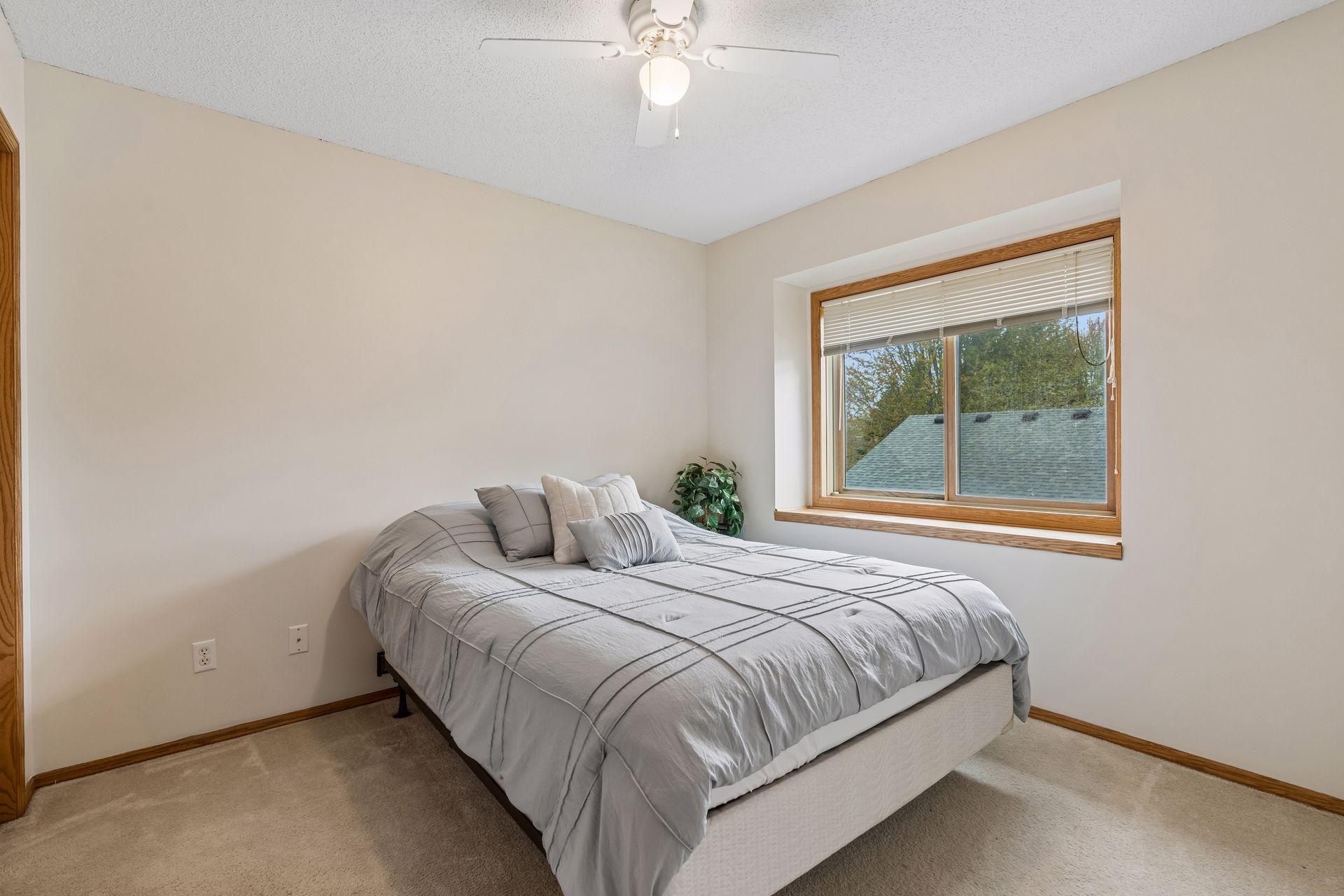 Third upper level bedroom, complete with ceiling fan and window ledge.