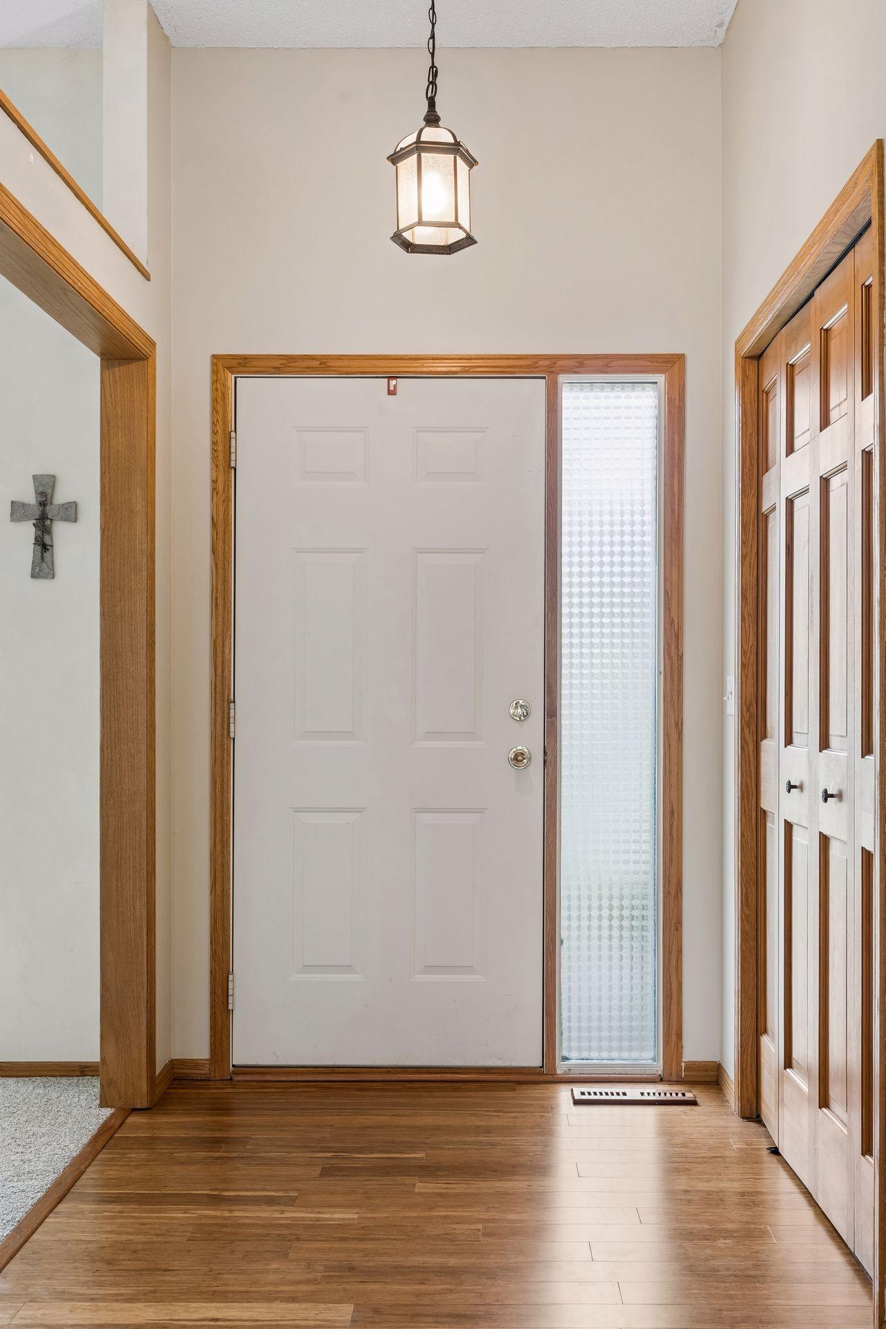 Welcoming foyer with coat closet and open architectural sightlines to the living room.