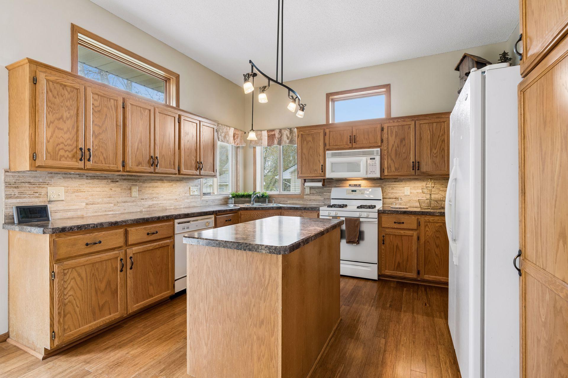 Spacious kitchen with center island, abundant cabinetry, and great prep and storage space throughout.