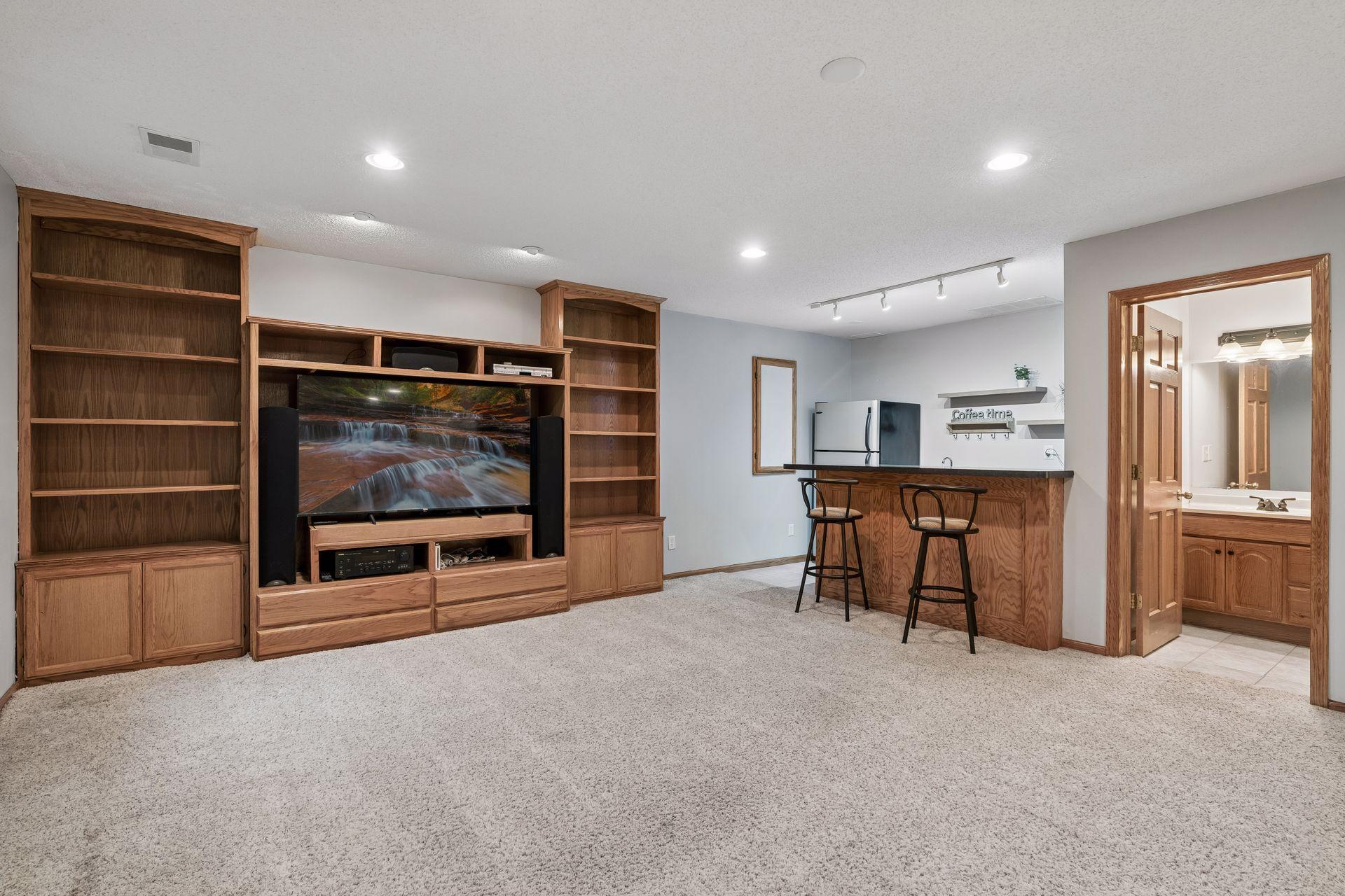 Custom built-ins add exceptional storage and display space while enhancing the functionality of the lower level entertaining area.