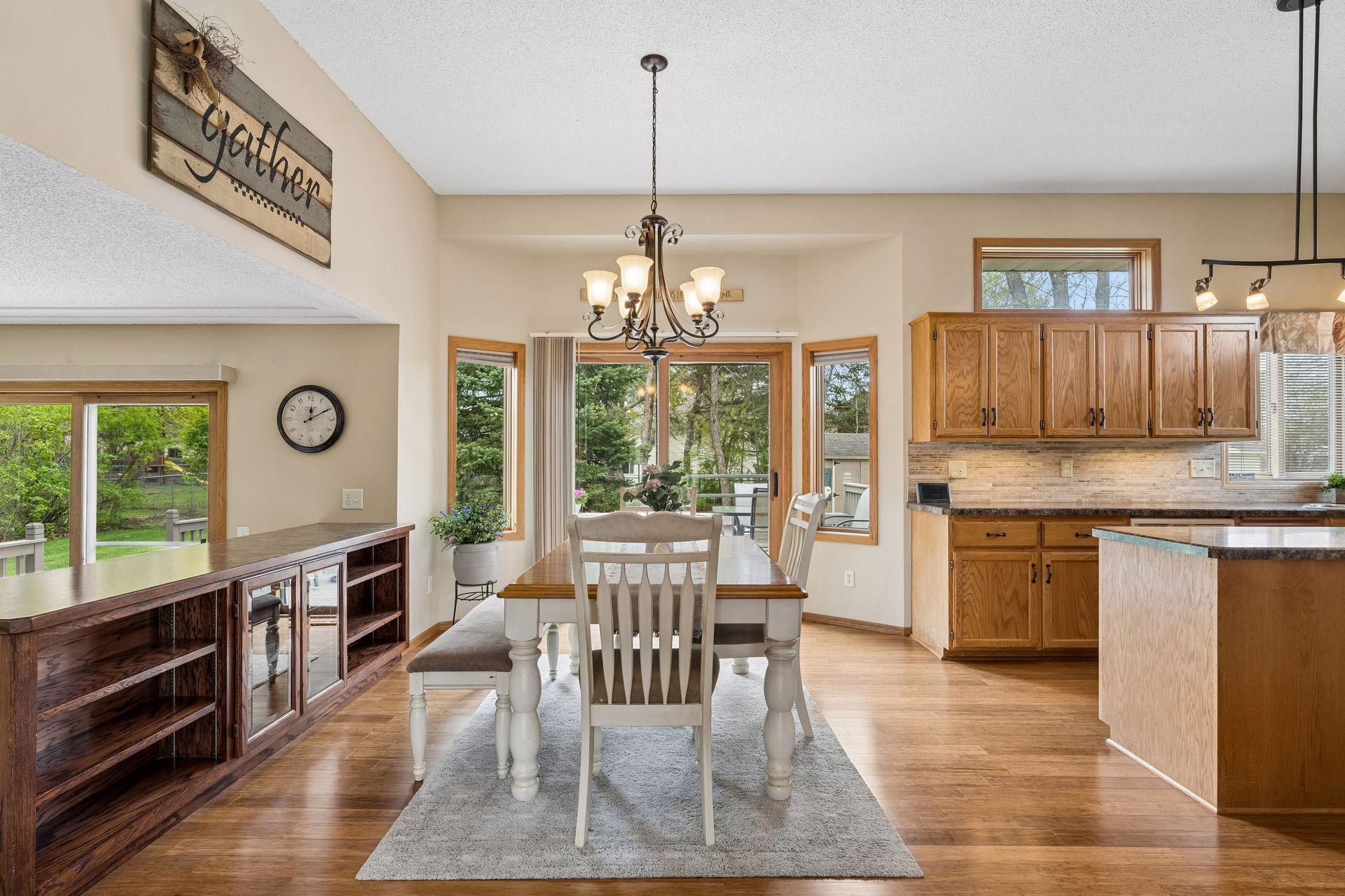 Informal dining space features custom built-ins, abundant natural light, and convenient access to one of the decks for easy indoor-outdoor living.