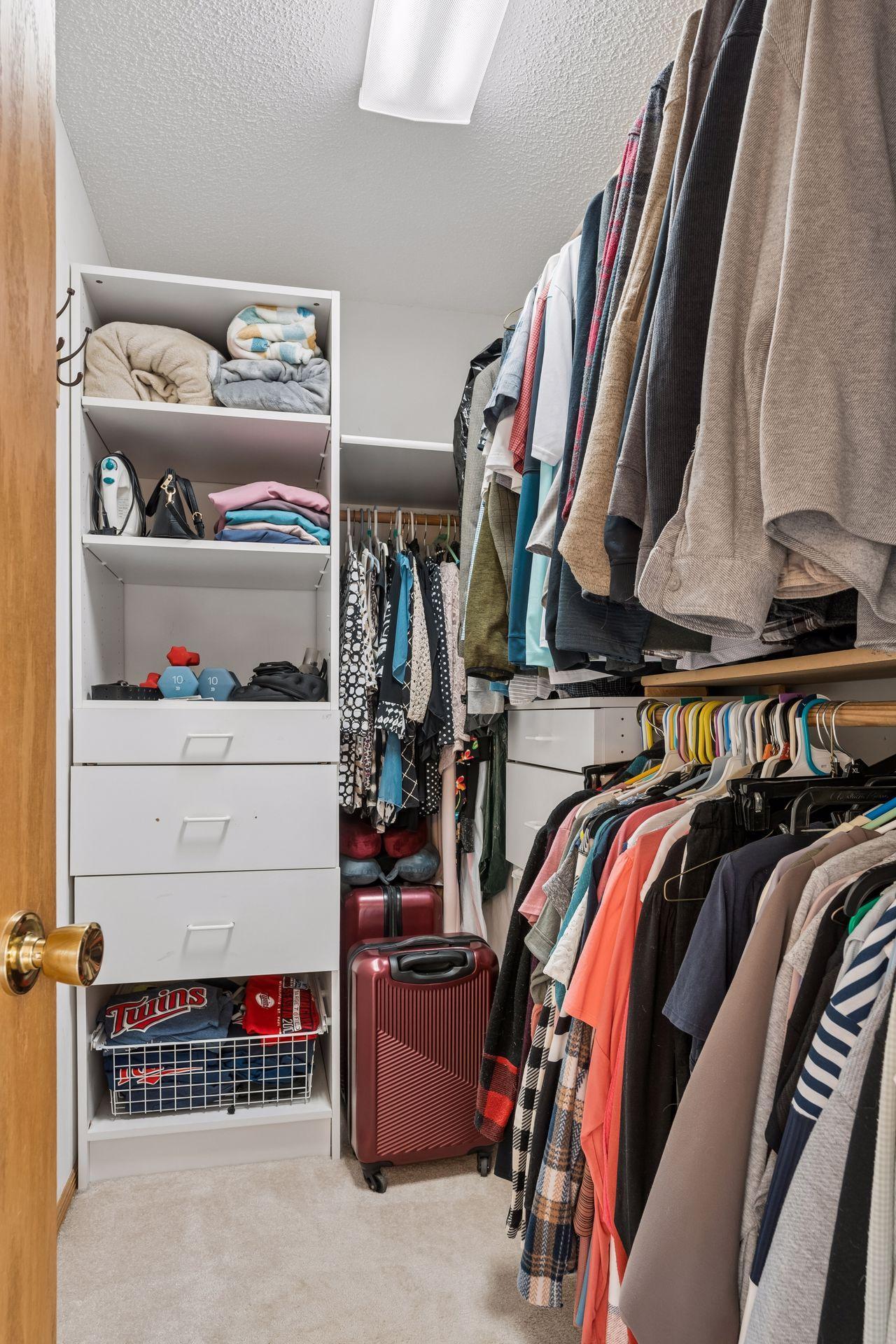 Walk in closet with closet storage system.