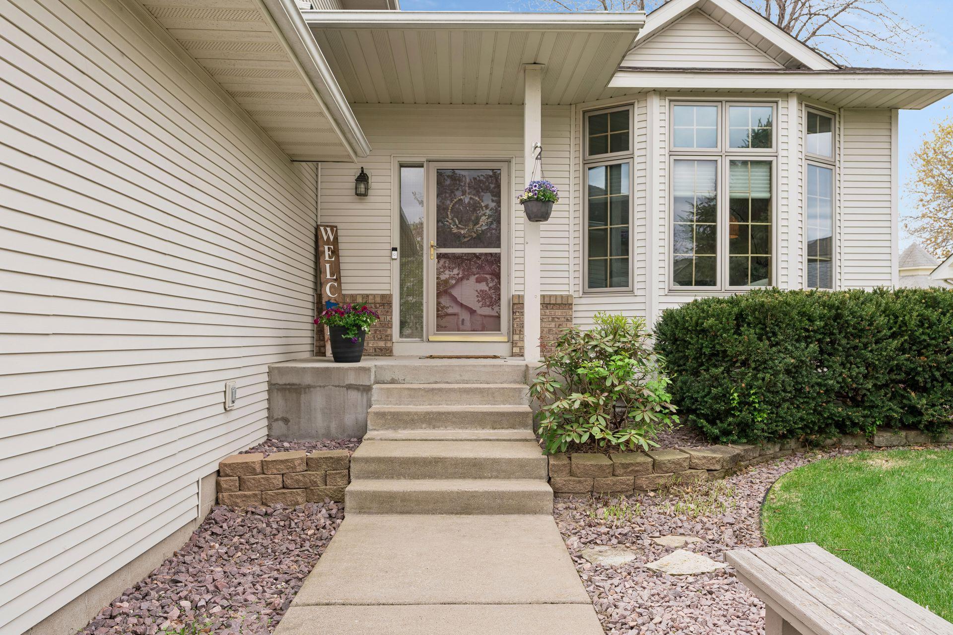 Welcoming front entrance with well manicured landscaping.