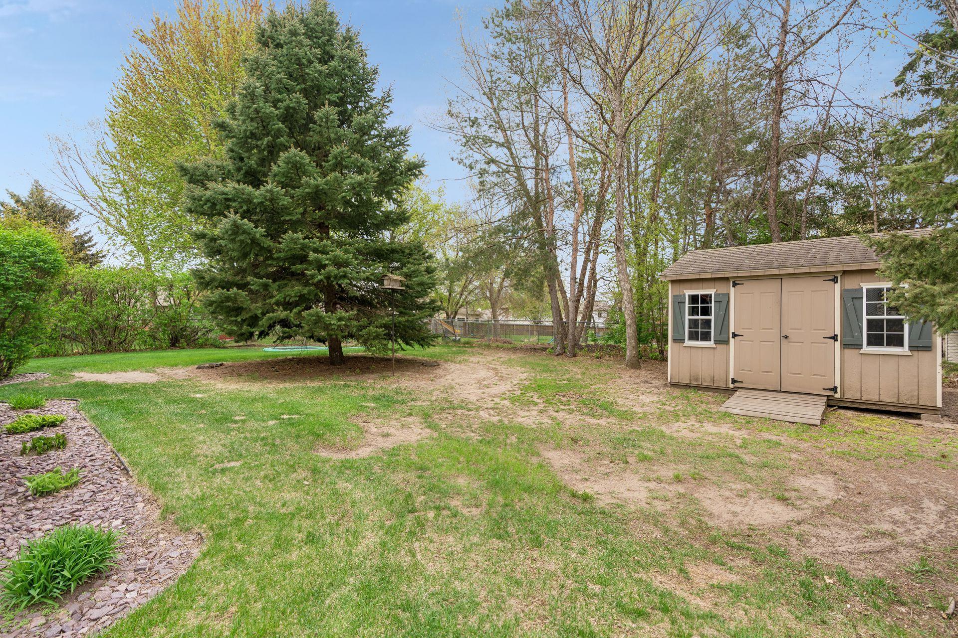 Backyard with large storage shed.
