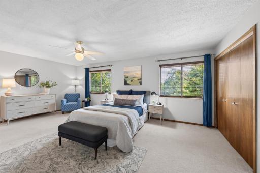 Very large, spacious primary bedroom with ceiling fan.