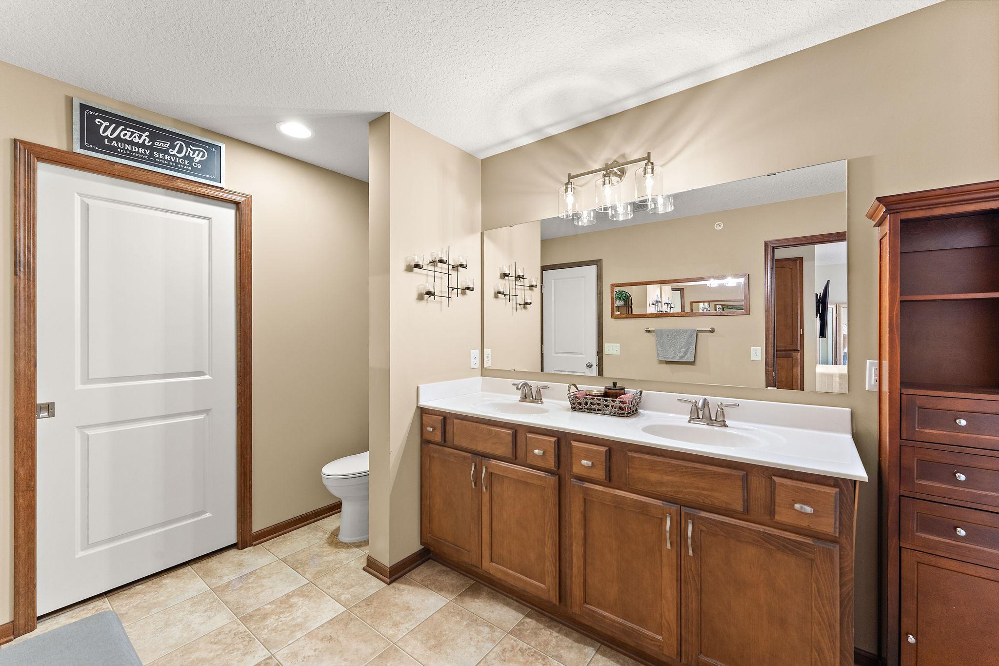 Another view of the full primary bath. A full sized washer & dryer are behind that door!