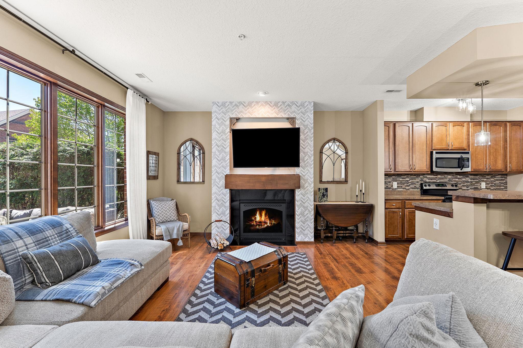 A gas burning fireplace with custom tile surround anchors the livingroom.