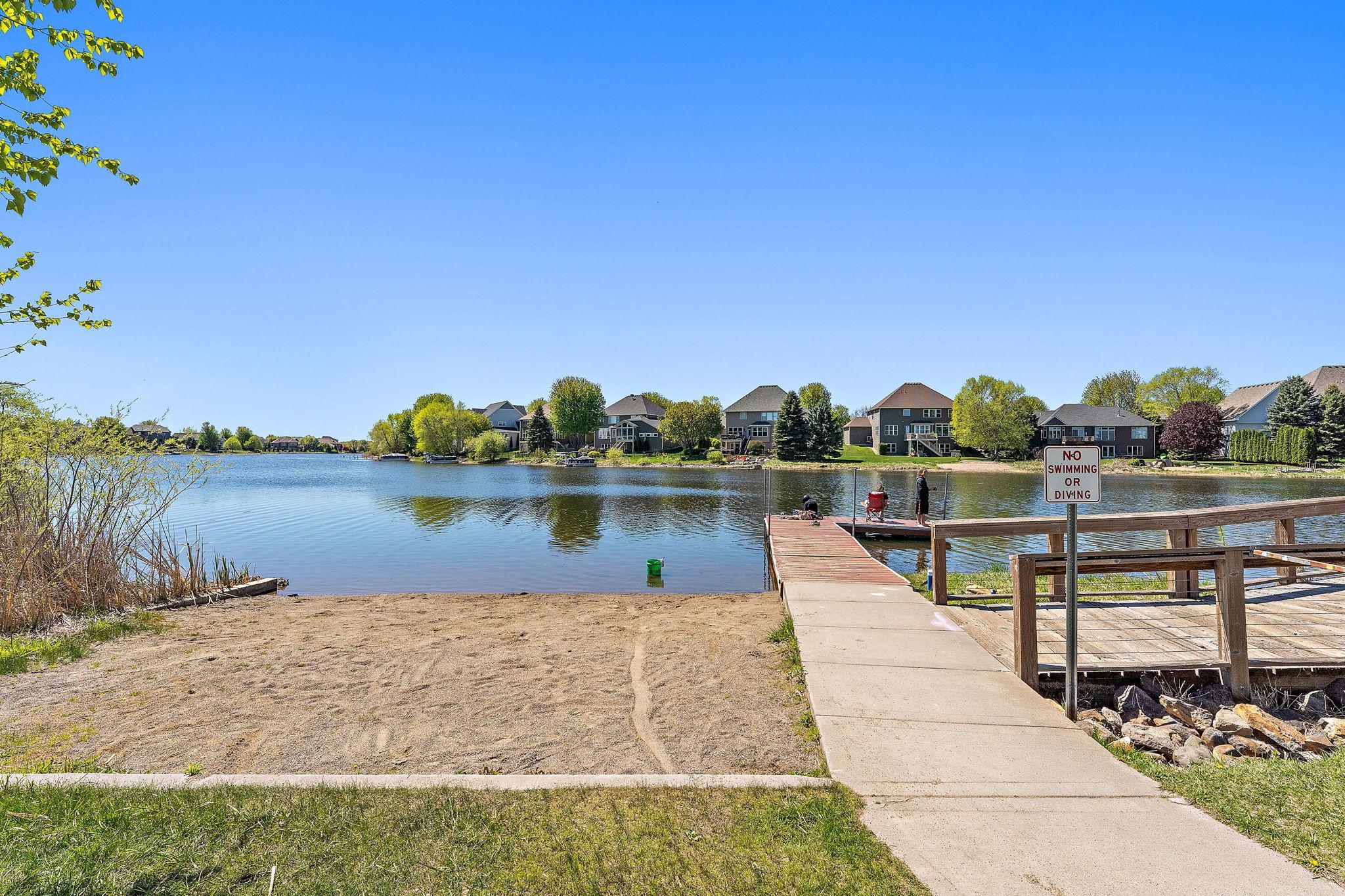 The Fishing Pier offers a dedicated space for fishing or simply taking in the view of the residential shoreline across the lake. This area is marked "No Swimming or Diving"