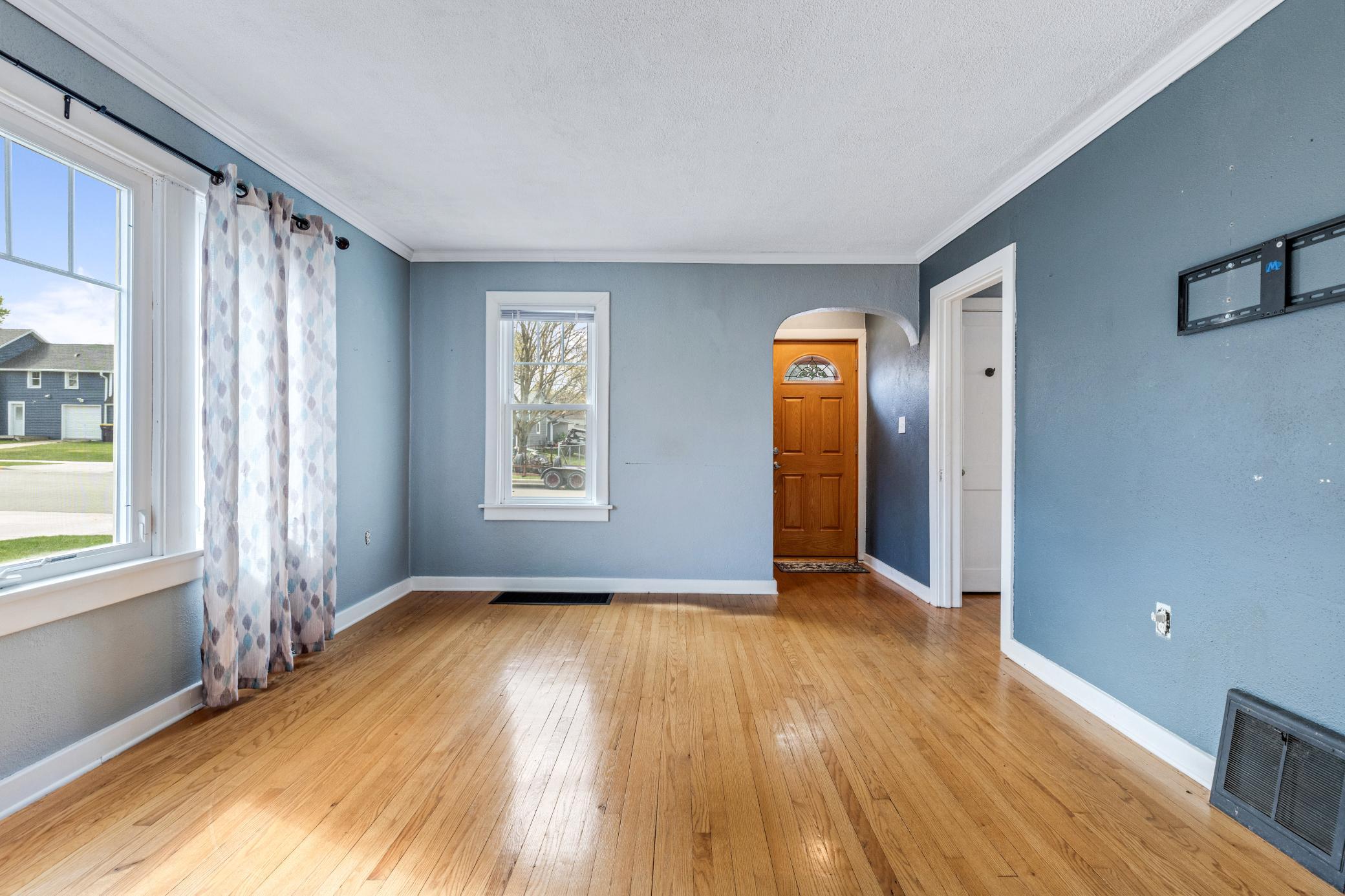 Living room: arched doors, beautiful wood floors.