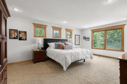 Primary bedroom is flooded with natural light.