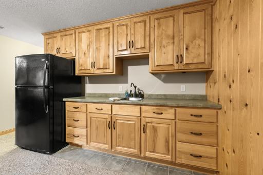 Beautiful cabinetry accents the rustic decor in the lower level.