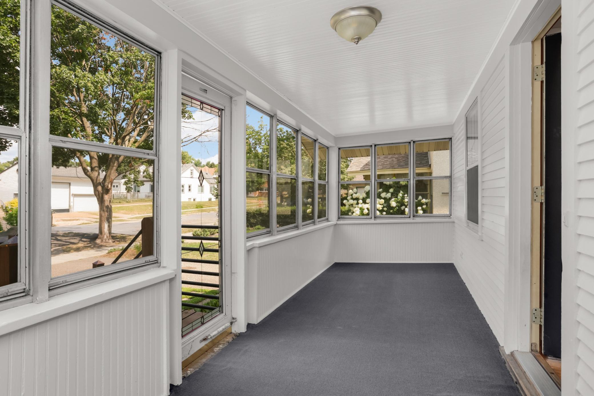 Enclosed front porch that is comfortable for that morning coffee!