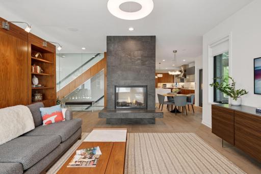Double-sided gas fireplace between living room and informal dining