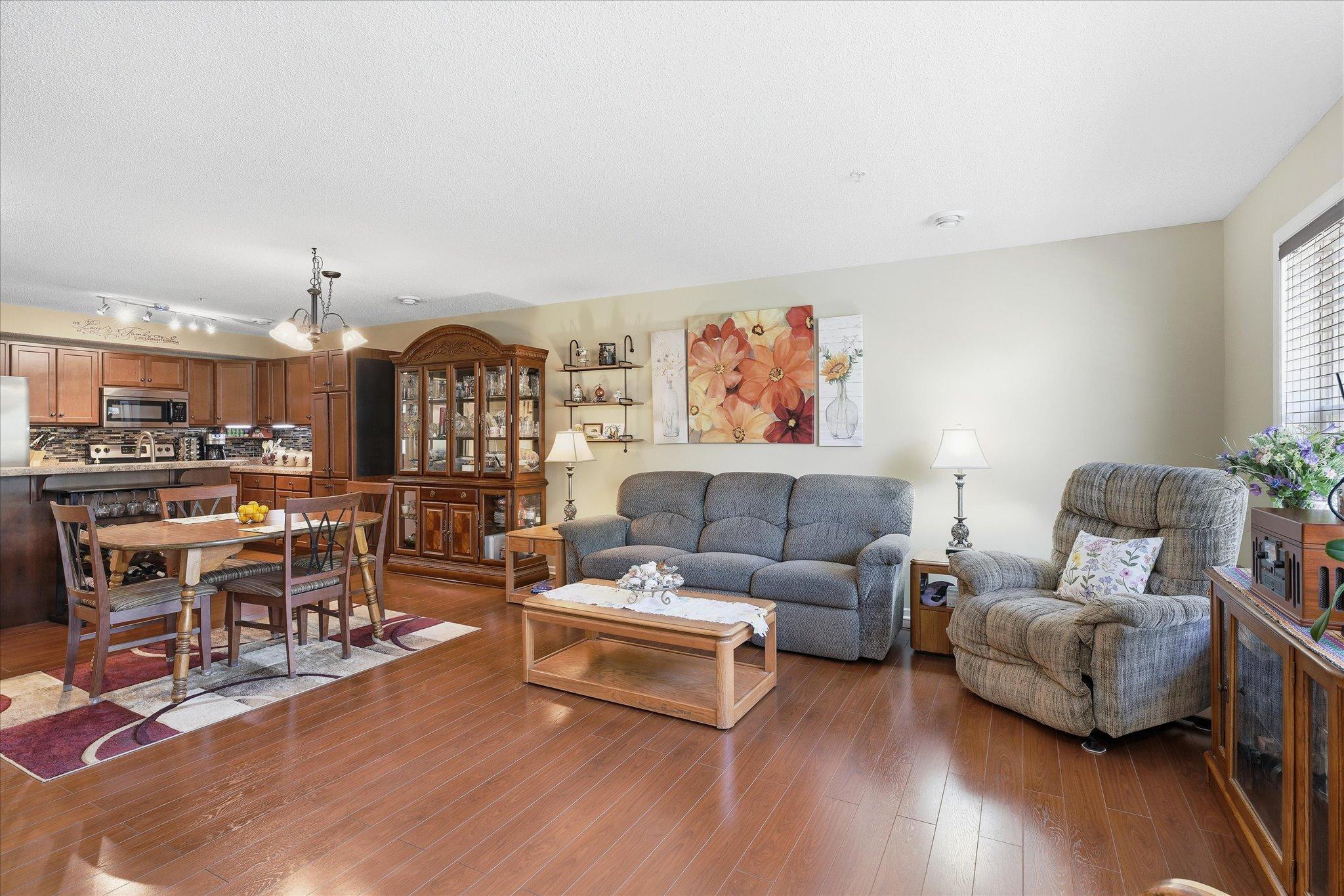 Open-concept main level with rich hardwood floors and seamless flow between the living, dining, and kitchen spaces.