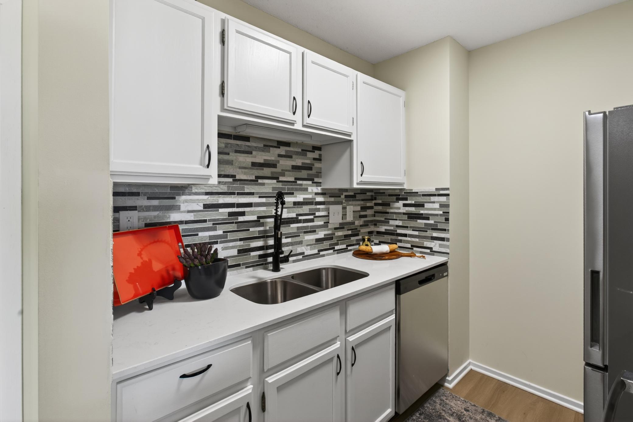 Kitchen-brand new quartz counters, LVP, backsplash, black stainless appliances