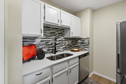 Kitchen-brand new quartz counters, LVP, backsplash, black stainless appliances