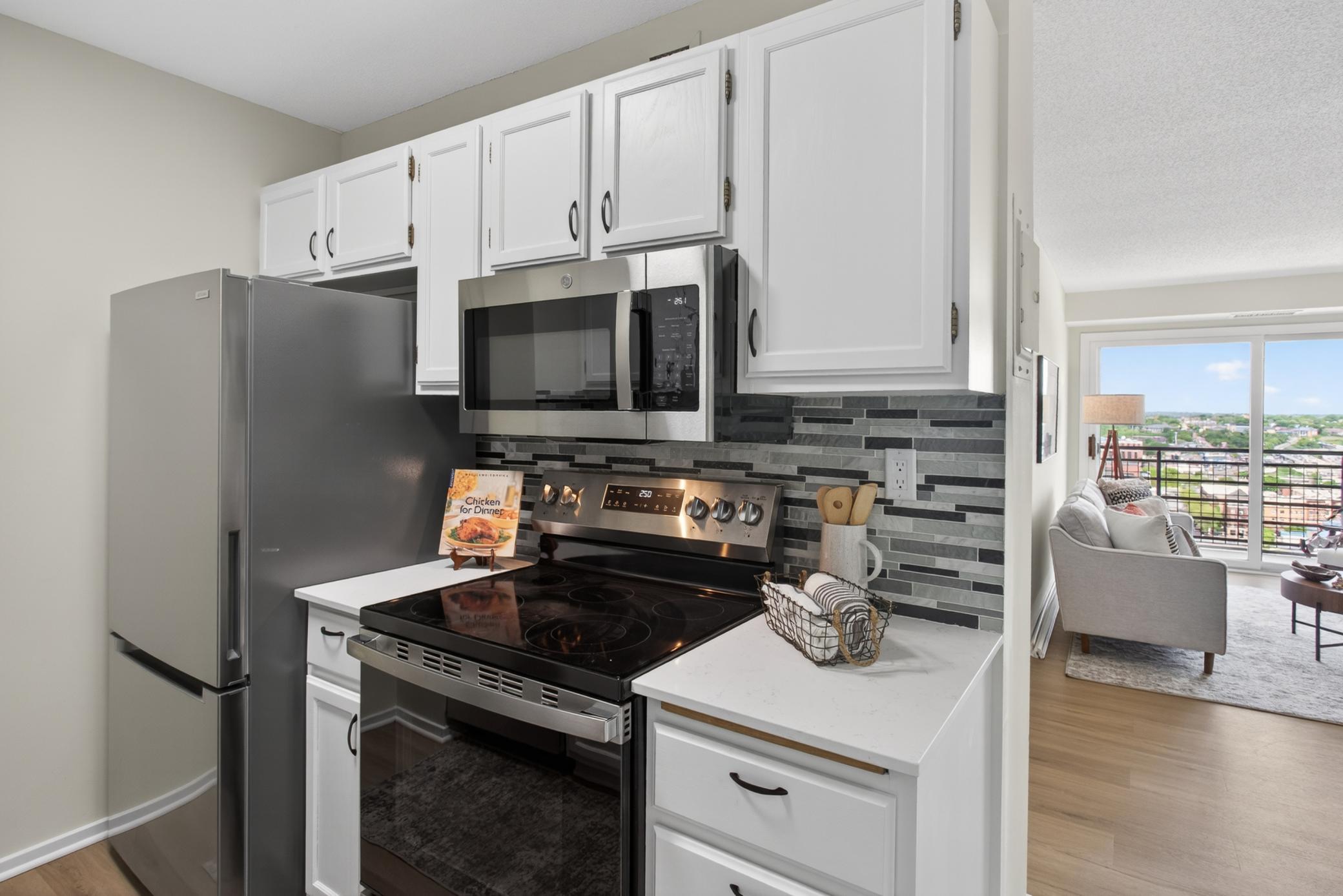 Kitchen-brand new quartz counters, LVP, backsplash, black stainless appliances