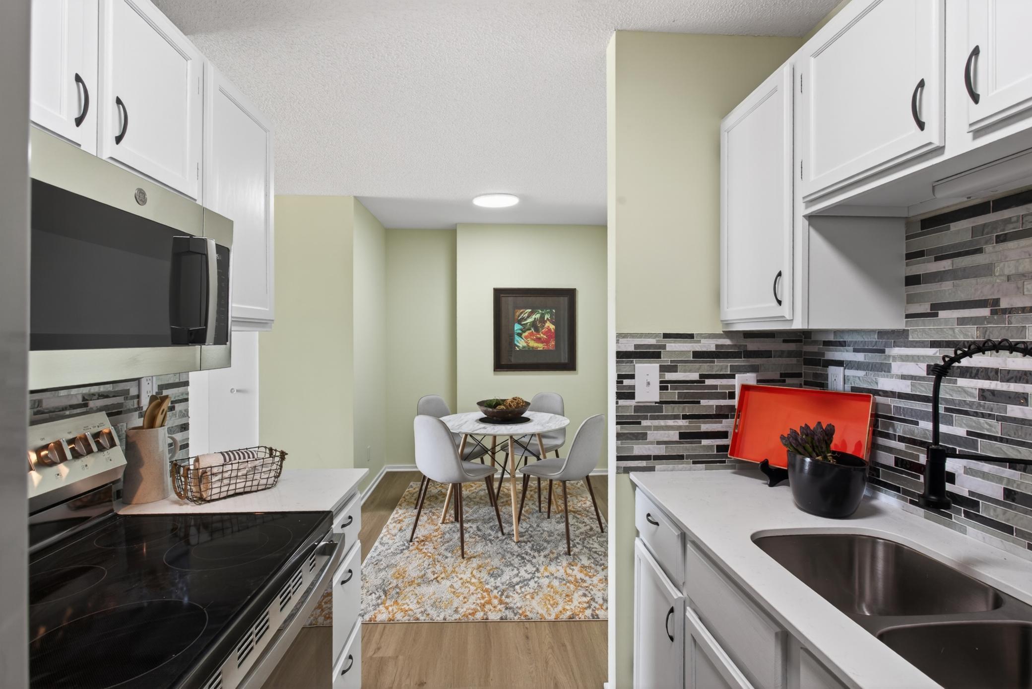 Kitchen-brand new quartz counters, LVP, backsplash, black stainless appliances