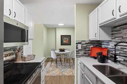 Kitchen-brand new quartz counters, LVP, backsplash, black stainless appliances
