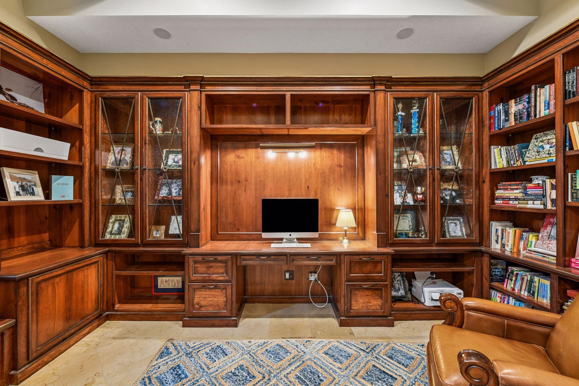 True craftsmanship shines in every corner - this private Home Office features wall-to-wall built-ins with custom cabinetry and shelving.