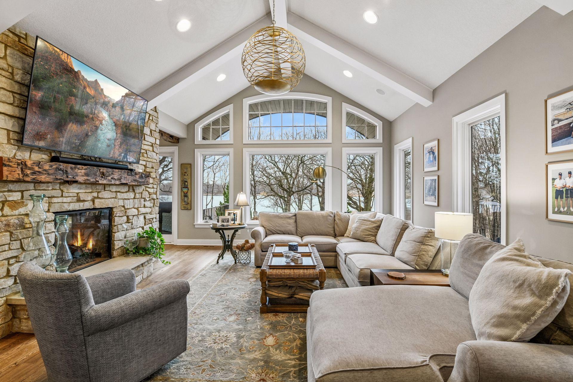 With vaulted ceilings and large window this Great Room enjoys commanding views of the pool and lake.