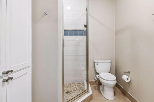 The 3/4 Bathroom features a tiled shower and built-in linen cabinetry.