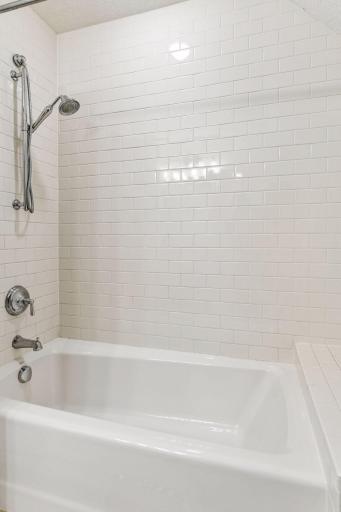 The tub and shower is surrounded with classic subway tile.