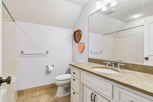 The upper level bedroom features a full en suite bathroom.