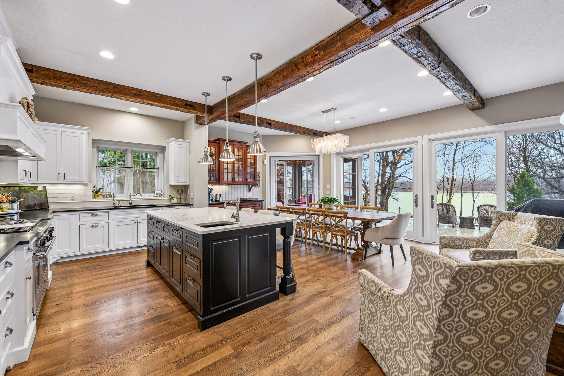 Step through to the well-designed Chef's Kitchen. With custom cabinetry and exposed beams, this inviting space is sure to become the central gathering place for any get-together.