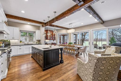 Step through to the well-designed Chef's Kitchen. With custom cabinetry and exposed beams, this inviting space is sure to become the central gathering place for any get-together.