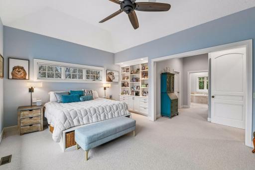 The space features separate walk-in closets with custom organizer systems - one closet features a stacking washer and dryer making the home truly main-level living.