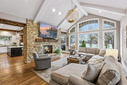 With soaring vaulted ceilings and large window this Great Room enjoys commanding views of the pool and lake.